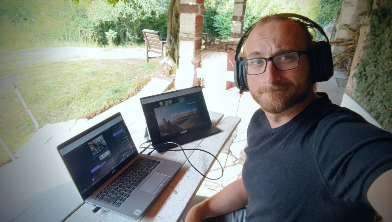 Dennis Kubitza with his laptop working outside